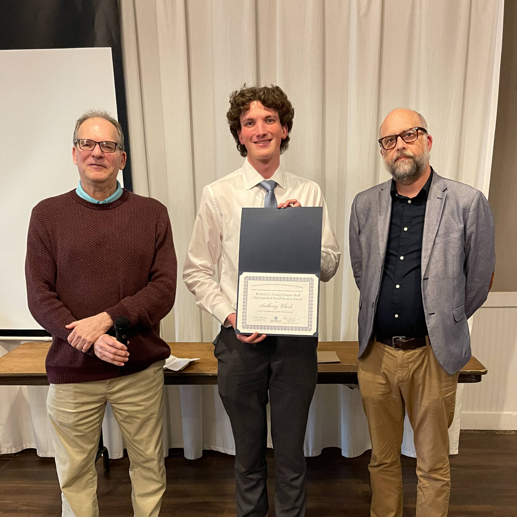 Anthony Clark holding award with professors Montagna & Huner